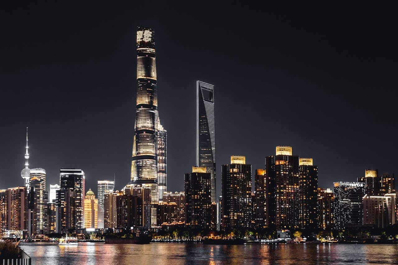 illuminated shanghai tower with highrise buildings