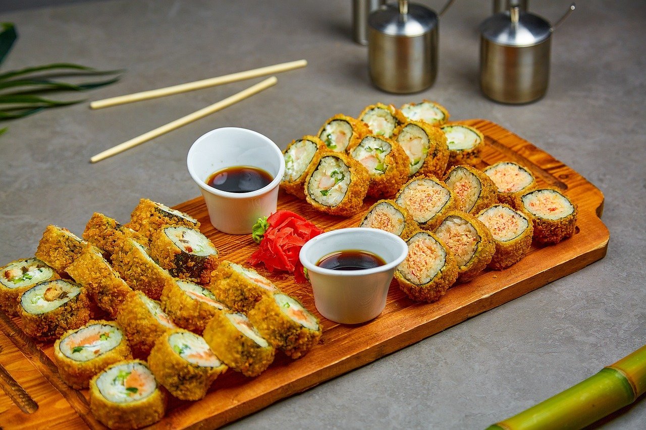 Sushi at Japanese restaurant with sauce and chopping board