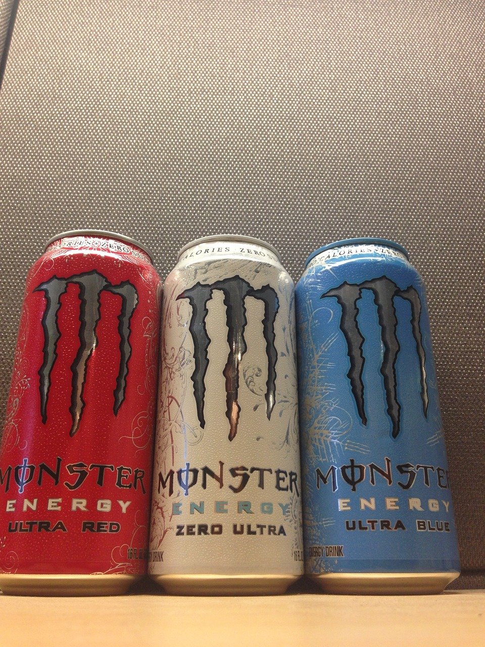 three different monster drinks on the table