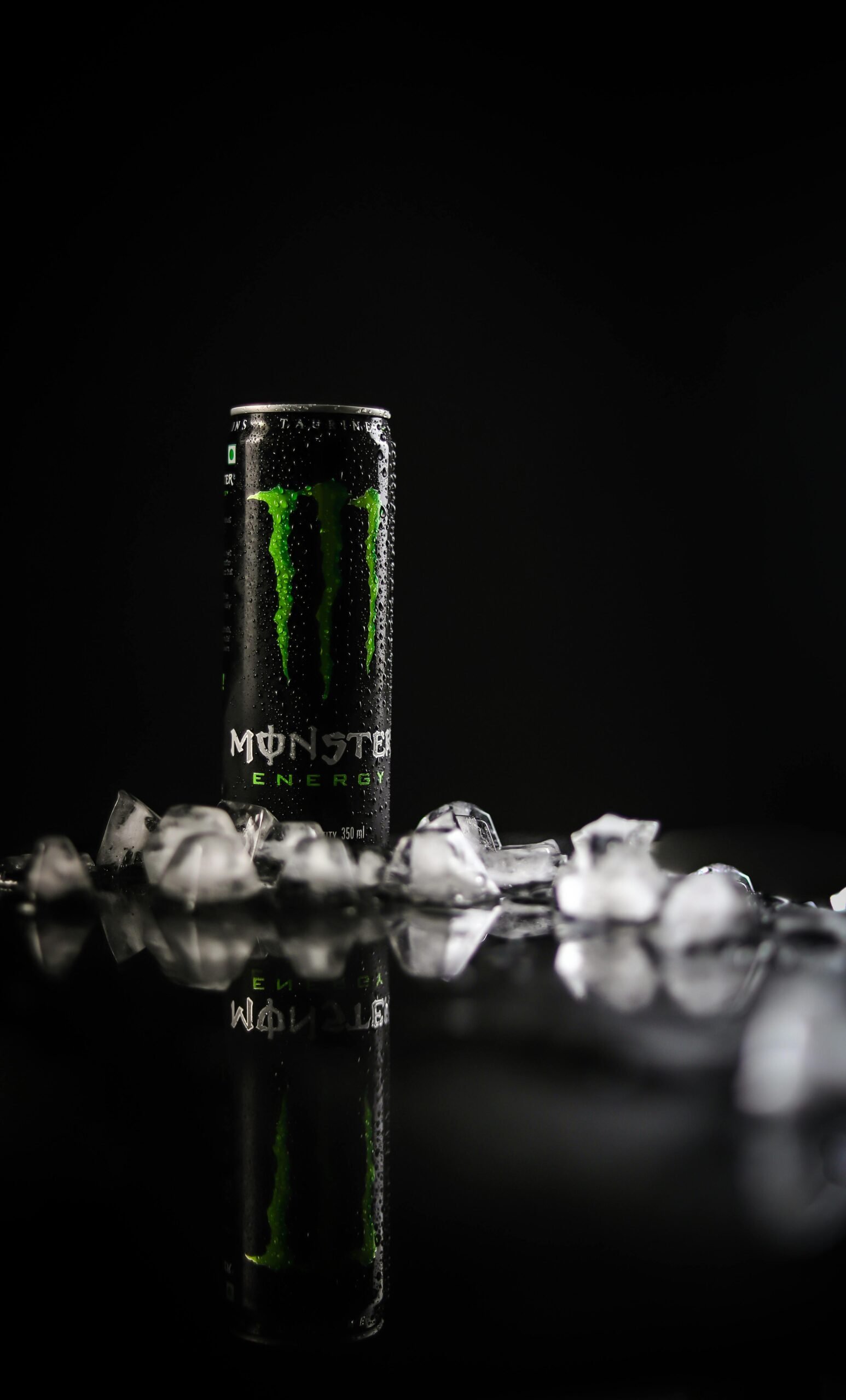 Monster Energy Tin Can on Black Surface with ice