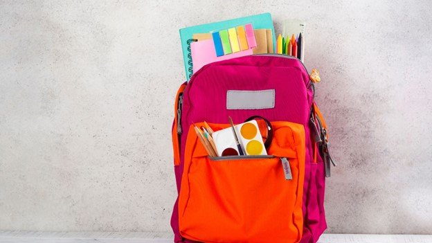 a red schoolbag with school supplies