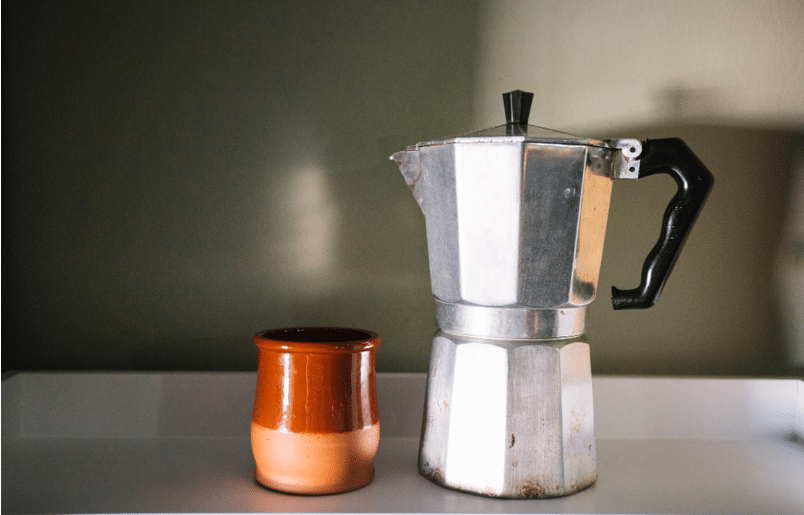 Coffee machine and a coffee cup on a table