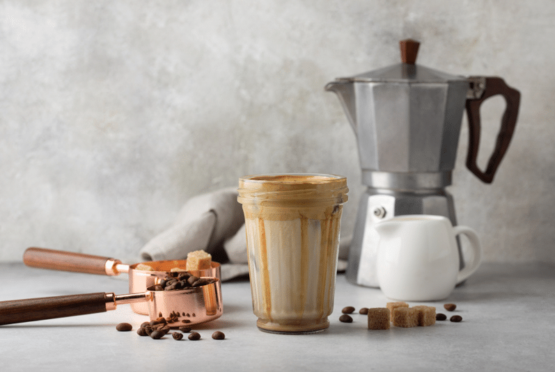 coffee griding in a coffee machine where there are other pots for making coffee