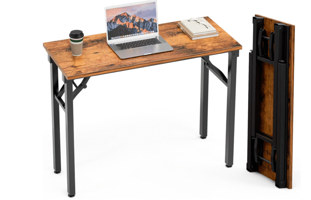 a brown table full view and folding table representing compact study desk in small room. also, a laptop on the table.