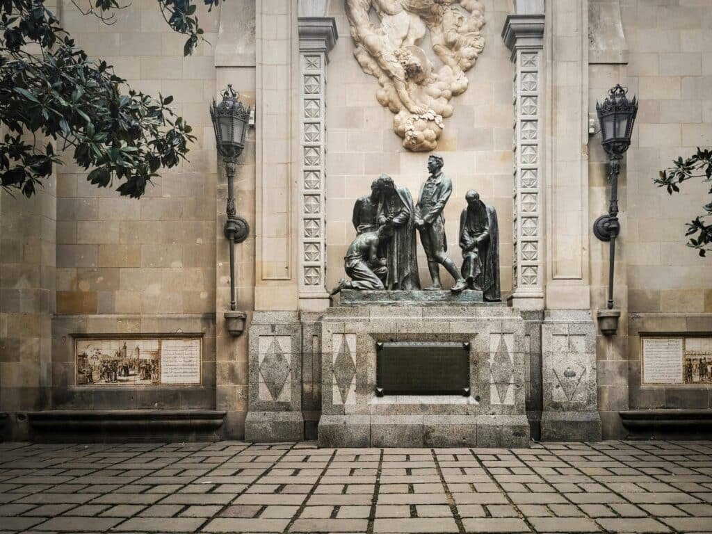 Classical stone monument adorned with detailed sculptures and decorative elements.